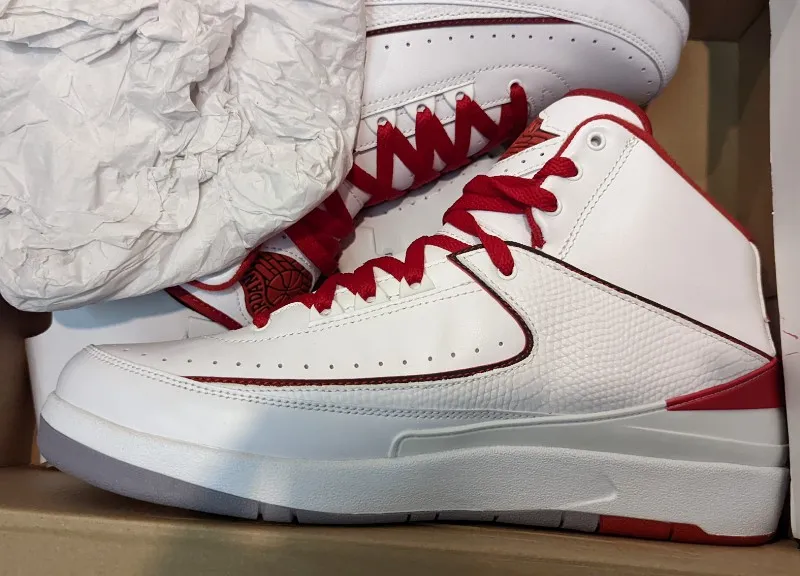 Air Jordan 2 Retro sneakers in white, black, varsity red, and cement grey